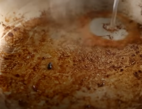 water poured into a pan containing remnants