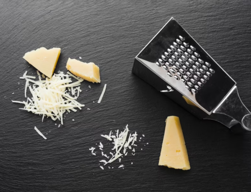 A grated parmesan cheese with a grater
