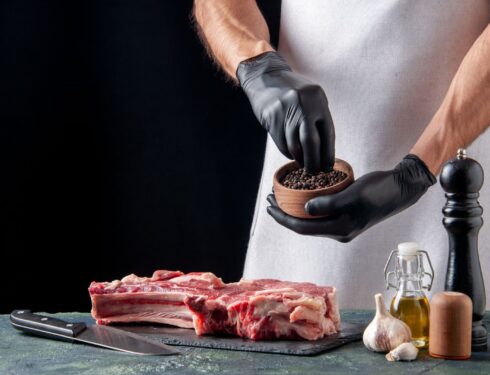 The chef seasoning steak